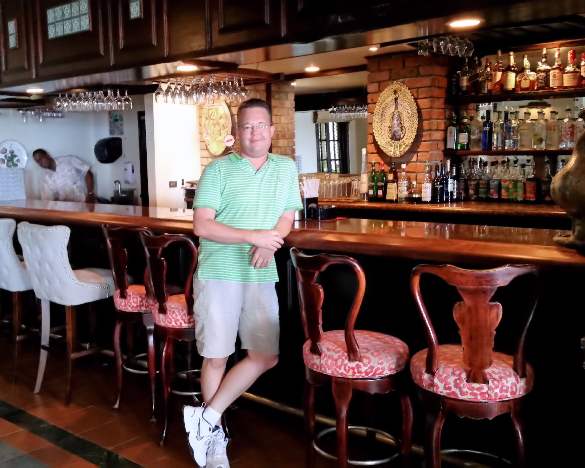 Travis standing at the bar where Ian Fleming would frequently visit while writing James Bond books
